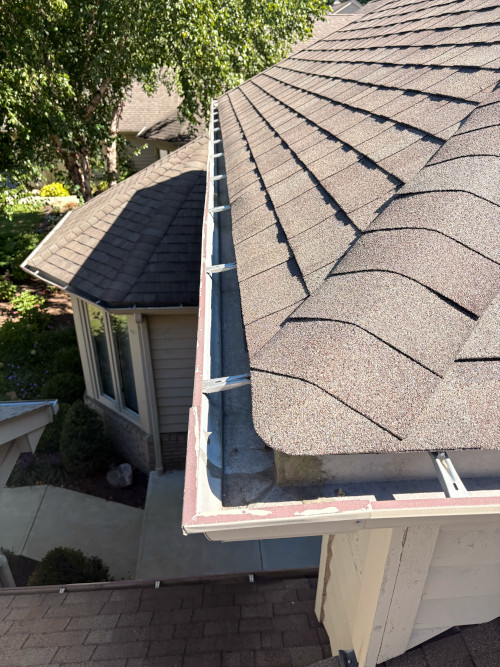 Residential gutter cleaning along a roofline